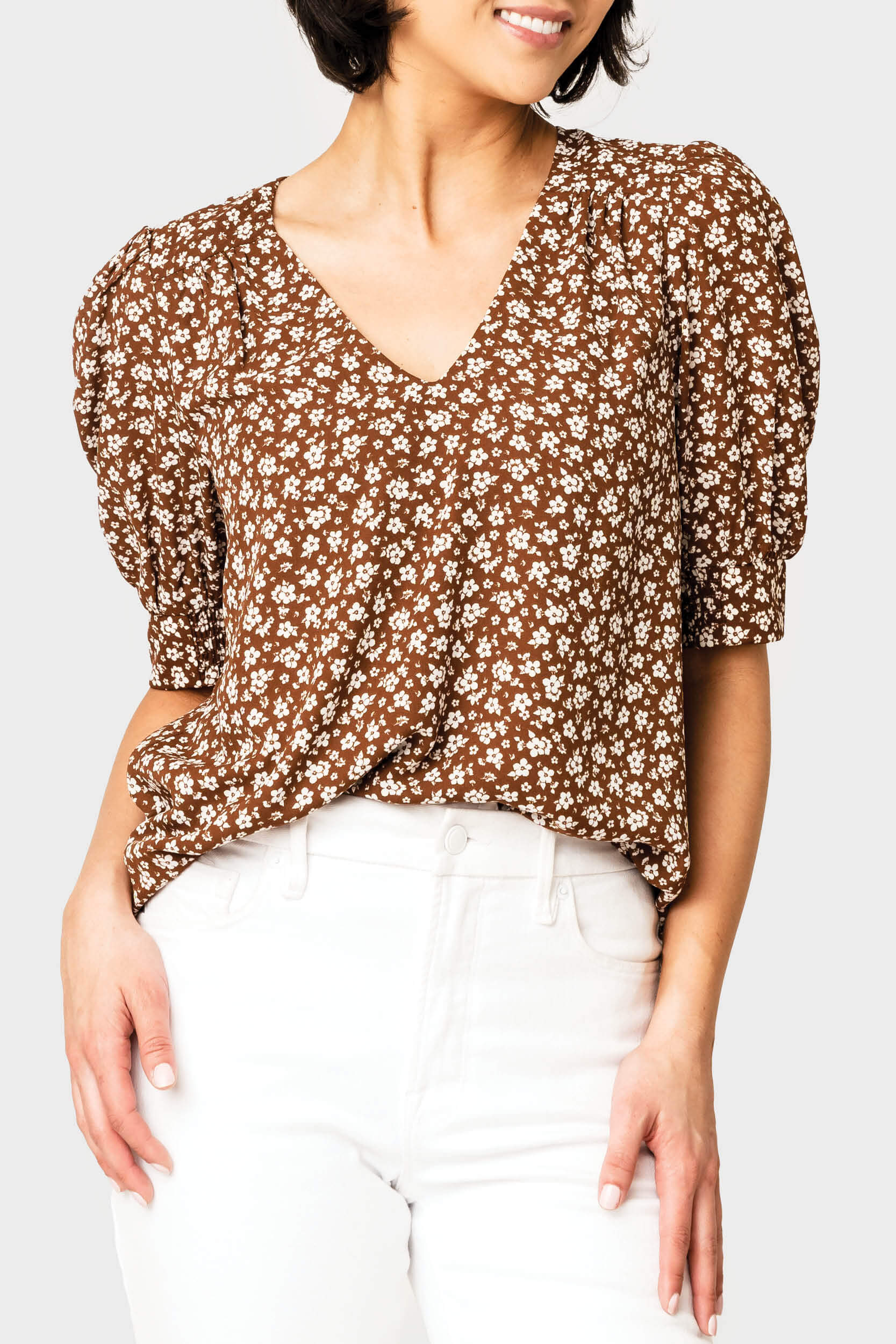 Front of women wearing the Puff Sleeve V-Neck Blouse in saddle ivory floral