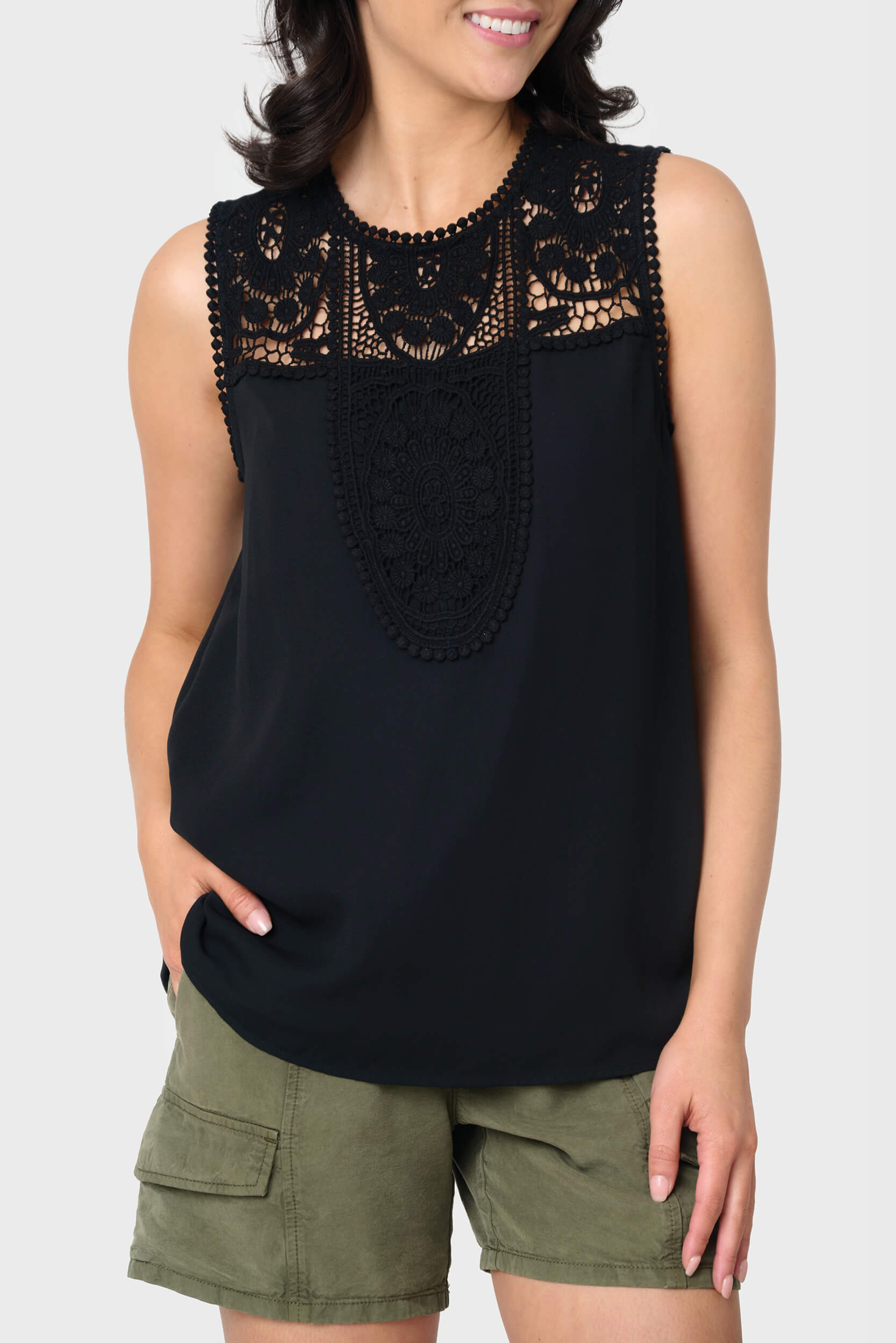 Woman modeling Luna Crochet Yoke Woven Tank in black styled for work to weekend