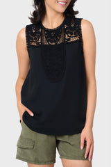 Woman modeling Luna Crochet Yoke Woven Tank in black styled for work to weekend
