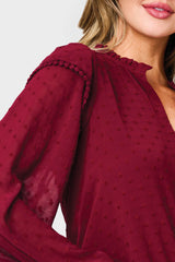 Woman modeling Holly Ruffled Cuff Blouse in Wine crochet trim detail