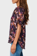 Side view Model wearing Dianthus Henley Puff Sleeve Chiffon Blouse in Purple floral print styled summer workwear