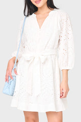 woman modeling 3/4 Blouson Sleeve Flare Eyelet Day Dress in white styled for work and everyday