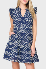 Woman modeling Flutter Sleeve Decked Out Day Dress in navy eyelet embroidery styled for warm weekends