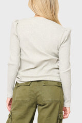 Person wearing a beige ribbed henley shirt and green cargo pants everyday casual