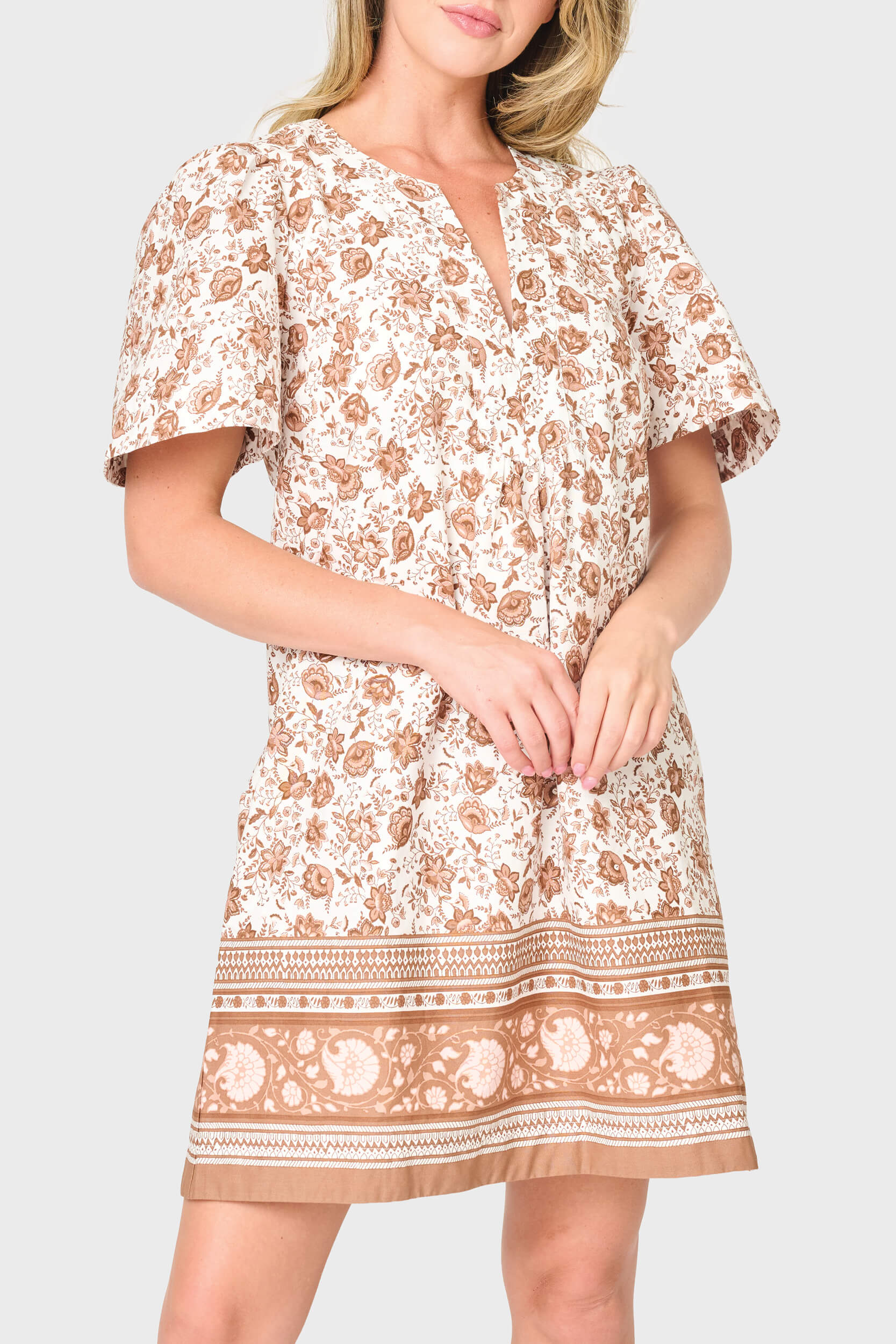 woman is modeling poplin Cabana Dress in Mocha Vine Border print styled vacations and everyday