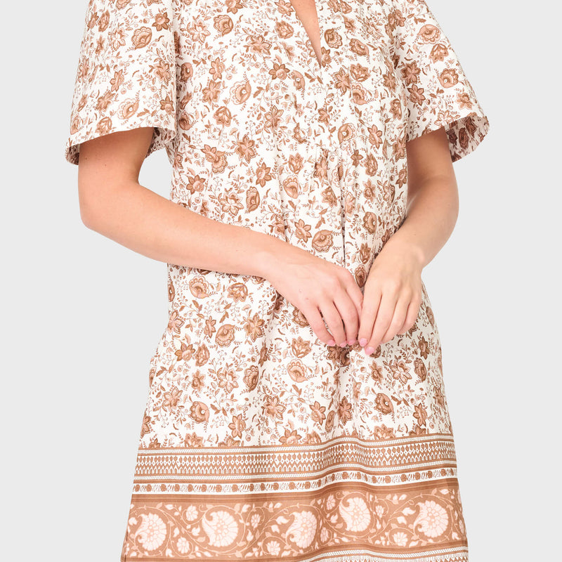 woman is modeling poplin Cabana Dress in Mocha Vine Border print styled vacations and everyday