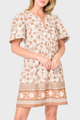 woman is modeling poplin Cabana Dress in Mocha Vine Border print styled vacations and everyday