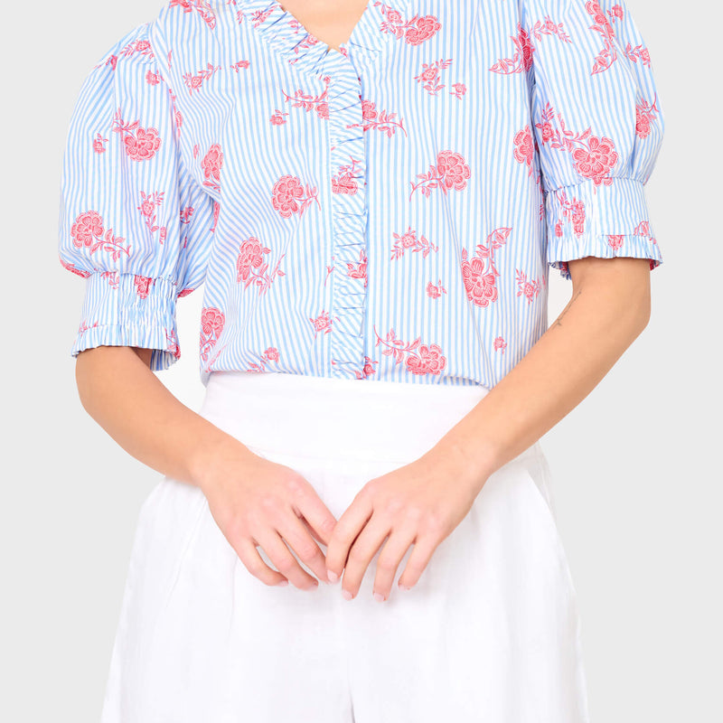 Woman modeling Iris Ruffle Front Button Down Top in Nautical Rose stripe print, styled for summer, vacations, and everyday