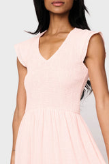 Woman modeling Flutter Sleeve Smocked V Neck Tiered Maxi Dress in Pearl blush
