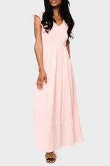 Woman modeling Flutter Sleeve Smocked V Neck Tiered Maxi Dress in Pearl blush pink, styled for vacation
