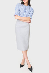 woman is modeling the Notch Midi Skirt in heather grey knit styled for work