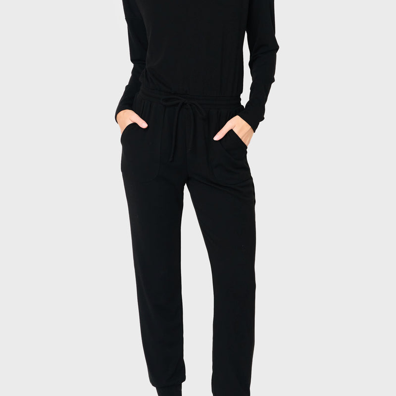 Woman modeling the Off Shoulder Soft Luxe Jumpsuit in black styled casual and cozy