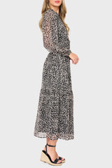 Side of Woman modeling Leyla Smocked Maxi Dress in Black Cheetah print styled business casual