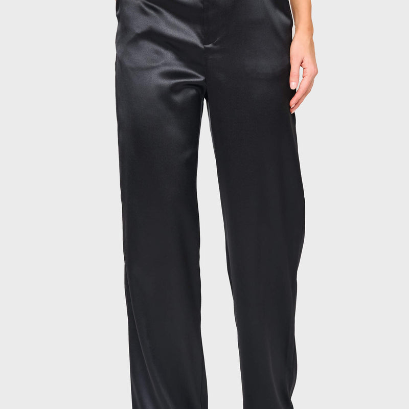 Woman modeling Stovepipe Satin Trouser in Black, styled business casual for holiday events