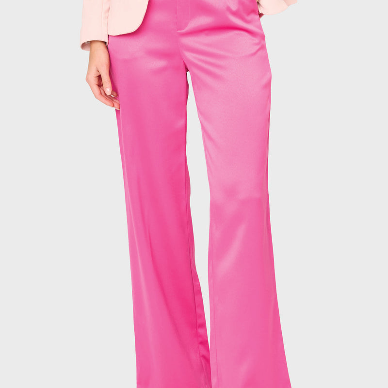 Woman modeling Stovepipe Satin Trouser in Fuchsia pink styled business casual for holiday parties