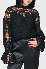 Woman modeling Lovely In Lace Flutter Cuff Blouse in Black styled for nights out, holiday events