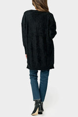 Back of Woman wearing Eyelash Boucle Cozy Knee Length Cardigan in Black Onyx