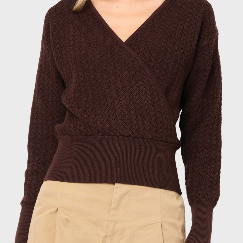 Woman modeling Pointelle Surplice Sweater in Espresso brown styled business casual