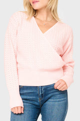 woman modeling Pointelle Surplice Sweater in light pink smoke, styled for work