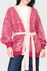 Woman modeling Friday Colorblock Sequin Cardigan in Red Pink style business casual for holiday parties