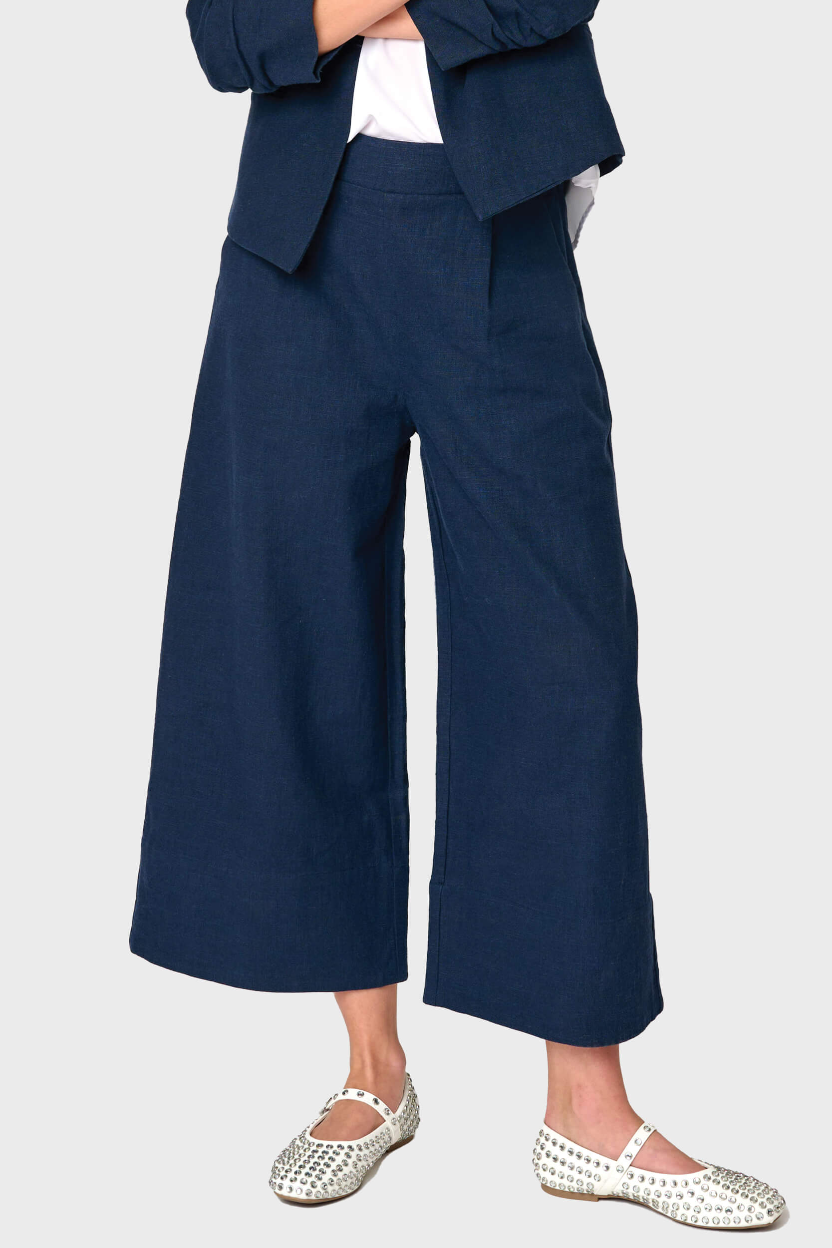 Woman modeling Wide Hem Cropped Linen Pant in navy blue styled as a set for work and everyday