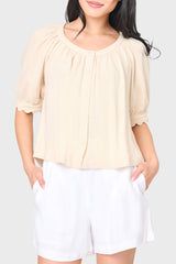 Woman modeling Lily Scallop Puff Sleeve Linen Top in Natural beige styled for vacations and weekends