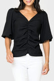 Front of women wearing the Balloon Sleeved V-Neck Textured Top in black