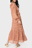 Side of women wearing the Moon River Smocked Ruffled Printed Maxi Dress in rust multi