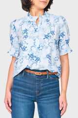 Woman modeling Dianthus Henley Puff Sleeve Blouse in Soft Sky Blue Floral styled for work and everyday