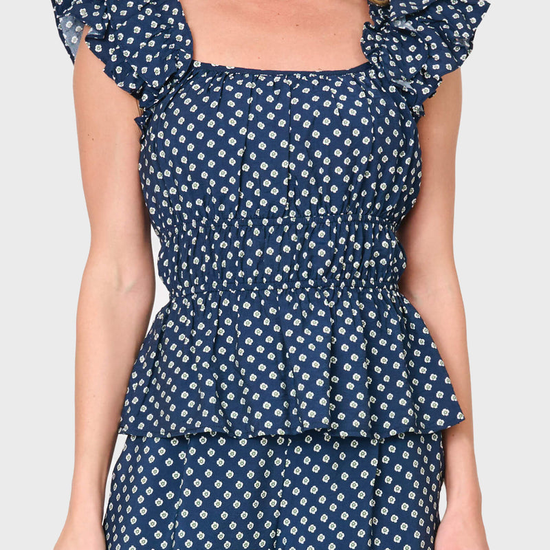 Woman modeling Elle Boho Flutter Sleeve Top in Navy daisy dot print styled as a set