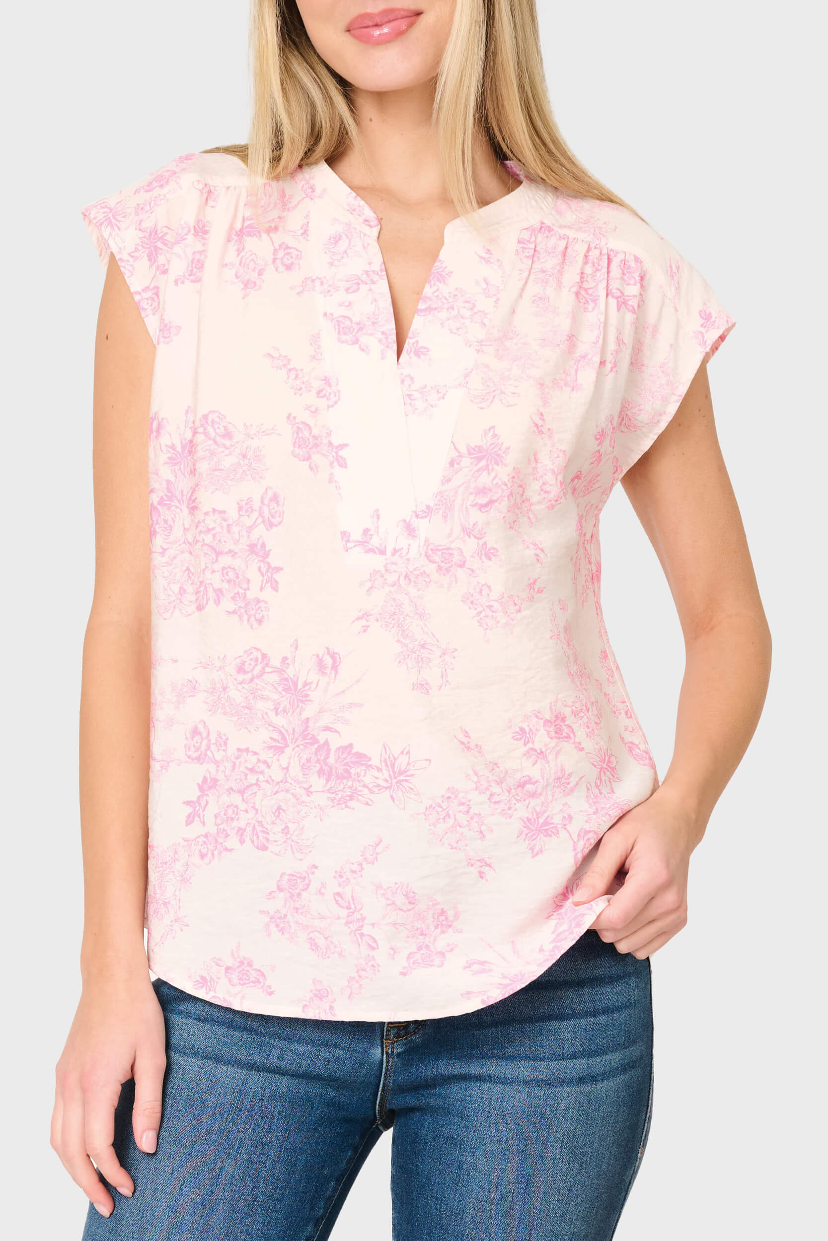 Woman modeling Cap Sleeve Notch Neck Blouse in Romantic pink toile styled for work and weekends