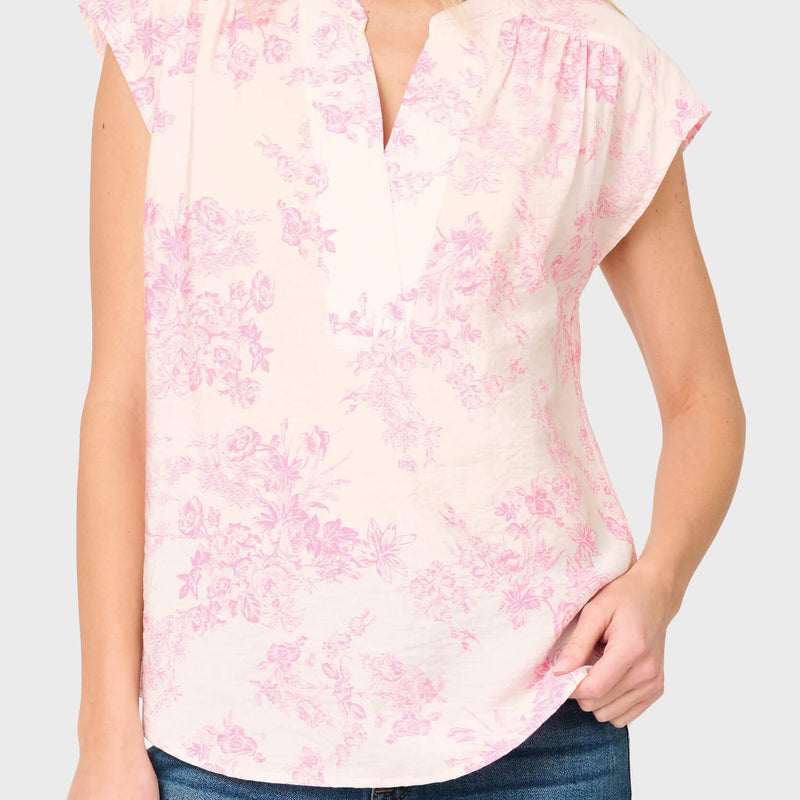 Woman modeling Cap Sleeve Notch Neck Blouse in Romantic pink toile styled for work and weekends