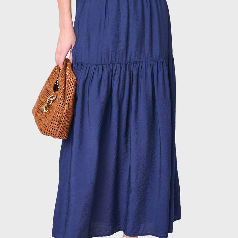 Woman modeling Playa Tiered Maxi Skirt in navy blue styled for work and everyday