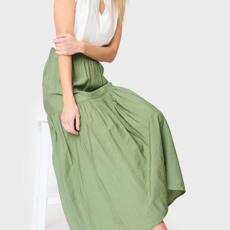 woman modeling Playa Tiered Maxi Skirt in vineyard green styled for work and everyday