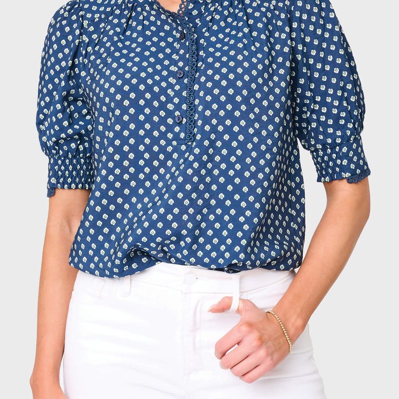 Woman modeling Dianthus Henley Crochet Trim Blouse in navy daisy print styled for work and everyday
