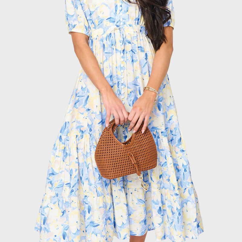 Woman modeling Kira Drawstring Midi Dress in Navy Yellow floral print styled for brunch, showers, and weekends