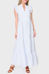 Woman wearing a white dress with blue patterns on a white background