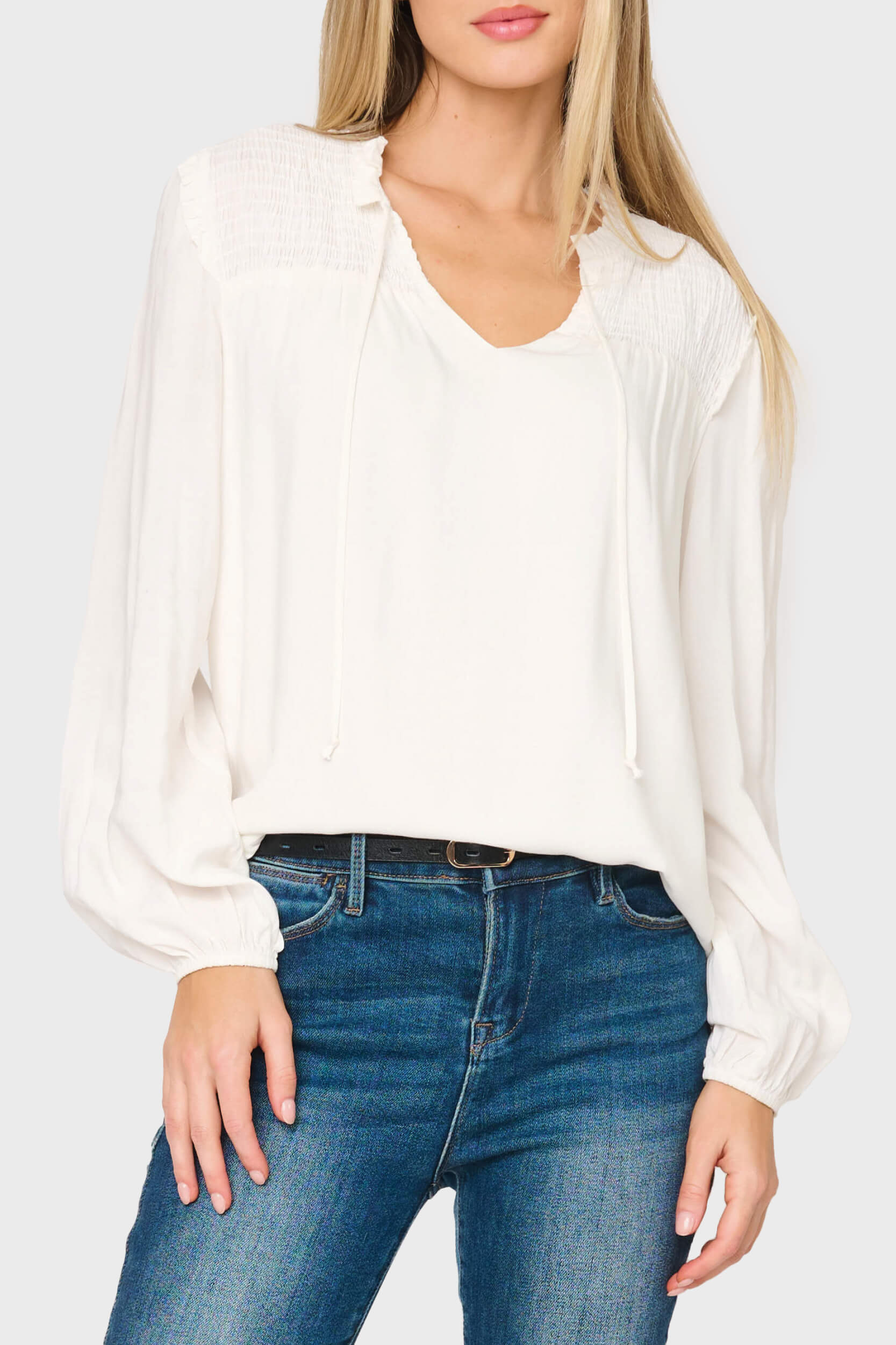 Woman modeling Smocked Yoke Tie Neck Blouson Sleeve Blouse in Ivory styled business casual
