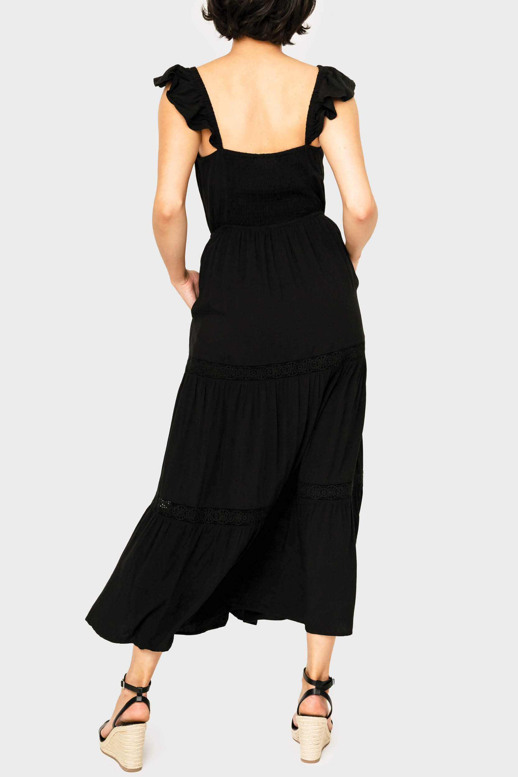 Back of women wearing the Strappy Crochet Inset Maxi Dress in black