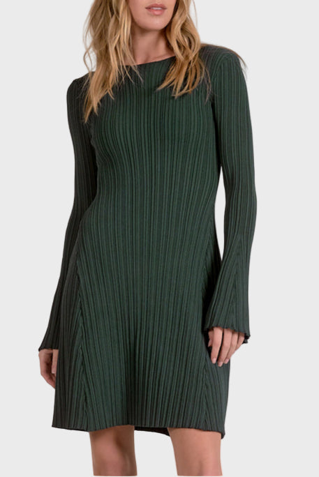 Woman wearing a green ribbed dress against a white background