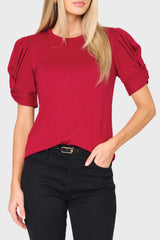 woman modeling Twist Sleeve Luxe Tee in red styled for work and for date night
