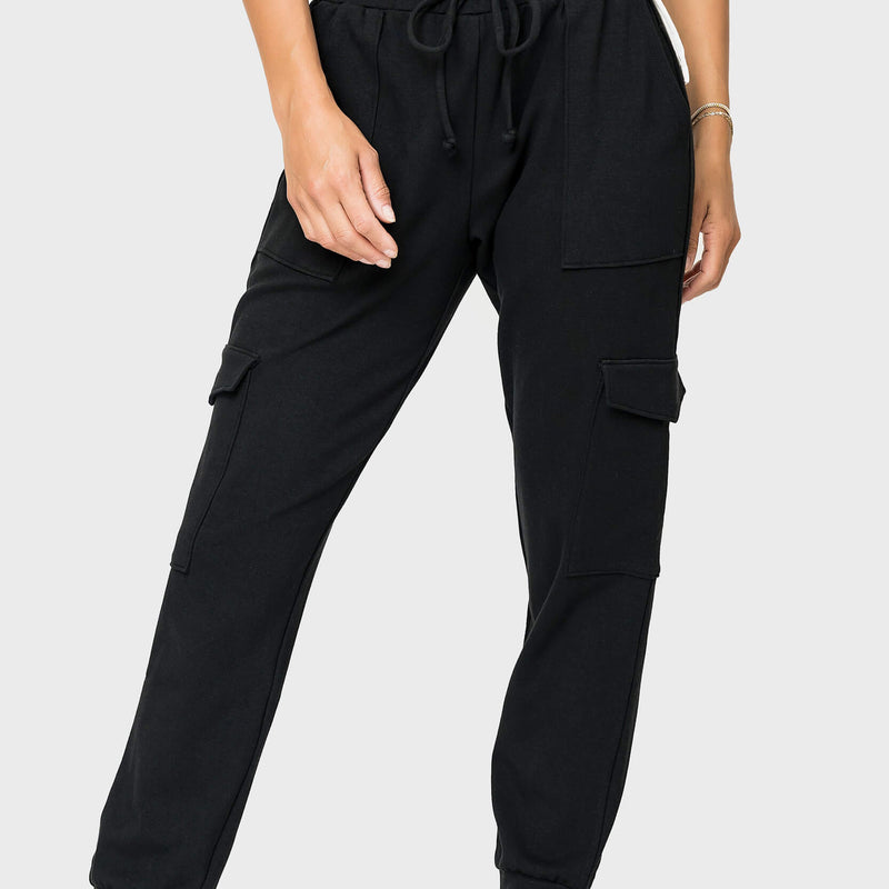 Front of women wearing the Gigi Essential Soft Ponte Cargo Jogger in black