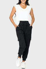 Front of women wearing the Gigi Essential Soft Ponte Cargo Jogger in black 