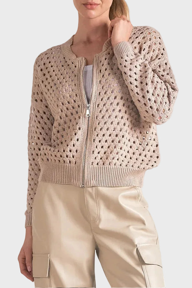 Woman wearing a beige knit cardigan on a white background