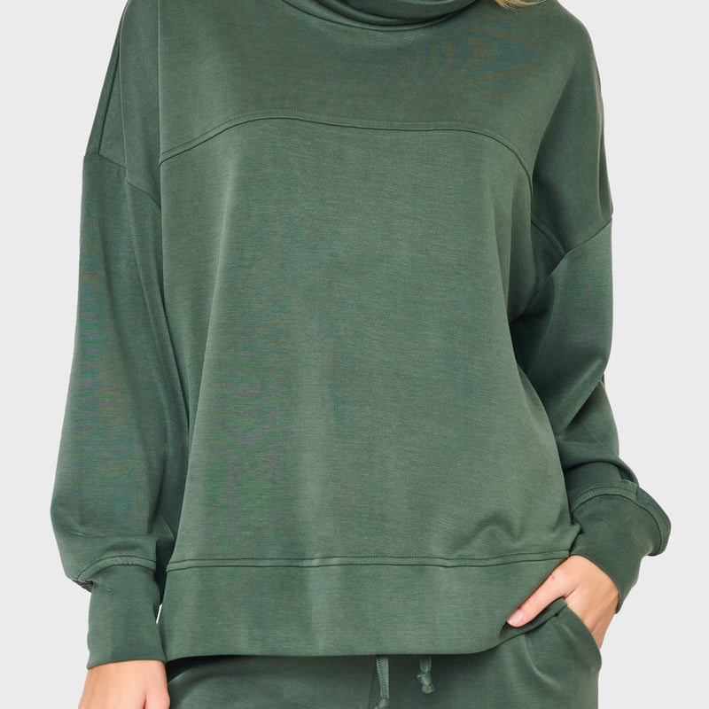 woman modeling Cloud Scuba Mock Neck Everywhere Top in green styled as matching set for lounging and weekends
