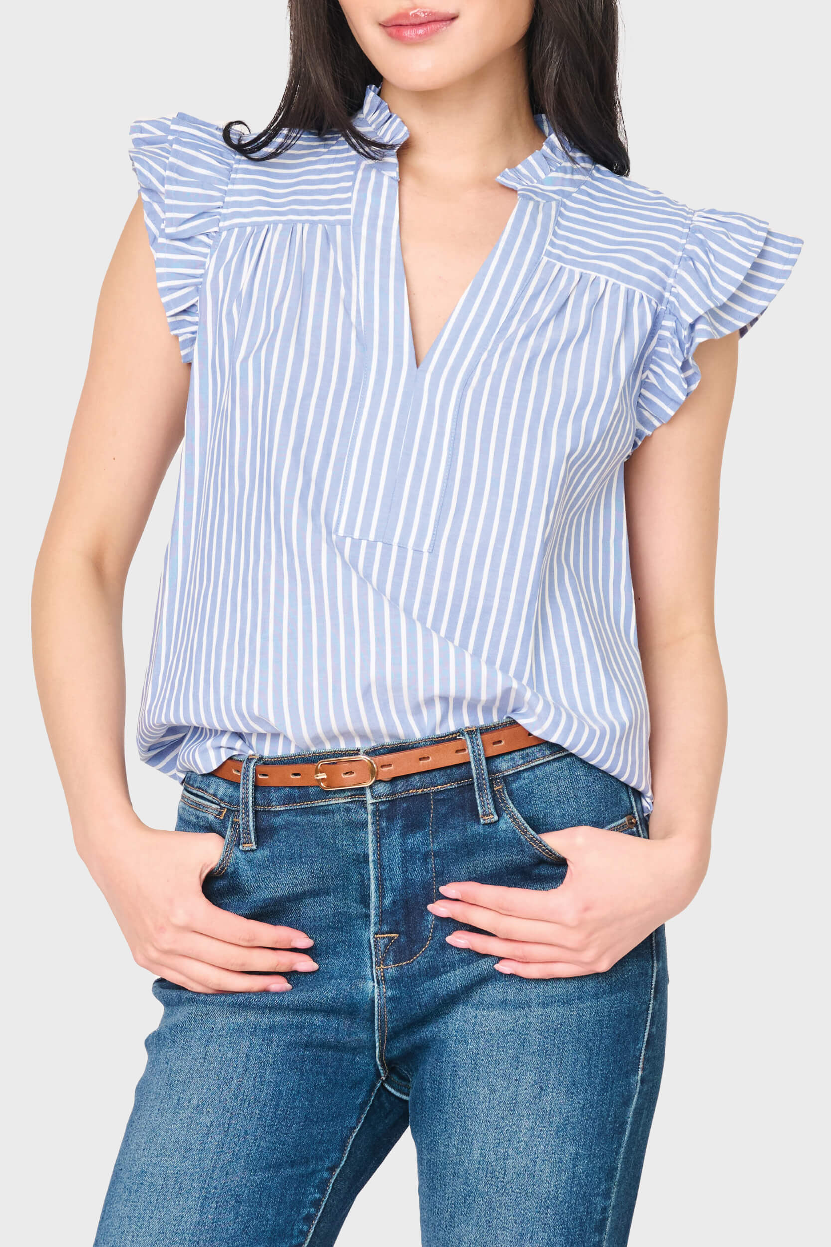 Woman modeling Flutter Sleeve V-Neck Stripe Top in blue white stripe styled for work to weekend
