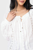 Close-up of women wearing the Elan Ruffle Trim Peasant Top in white