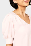 Close-up of women wearing the Puff Sleeve V-Neck Blouse in light dusty pink