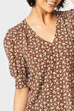 Close-up of women wearing the Puff Sleeve V-Neck Blouse in saddle ivory floral