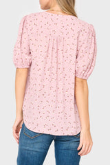 Back of Woman modeling Avery Elbow Sleeve shirt in pink floral print styled business casual